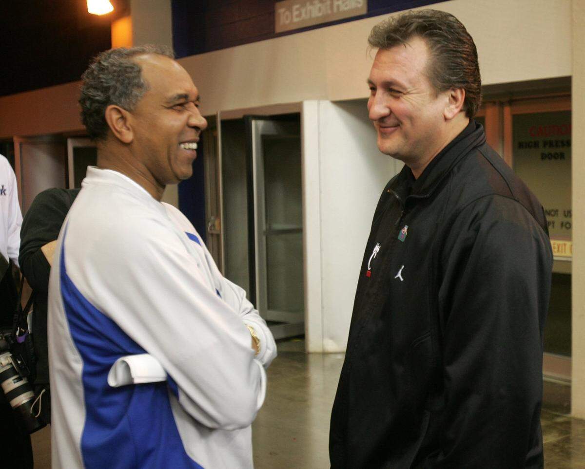 University of Kentucky basketball coach Tubby Smith, left, talked with Cincinnati coach Bob Huggins before the Wildcats took the floor for practice on March 16, 2005, at the RCA Dome in Indianapolis. Photo by Mark Cornelison | Staff