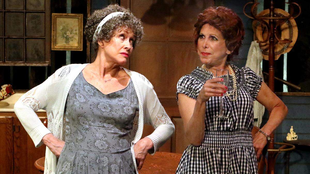Beulah (Patricia Hammond) and neighbor, Betty (Rita Hight) engage in a lively "pot luck" war in Pioneer Playhouse's production of "Granted."