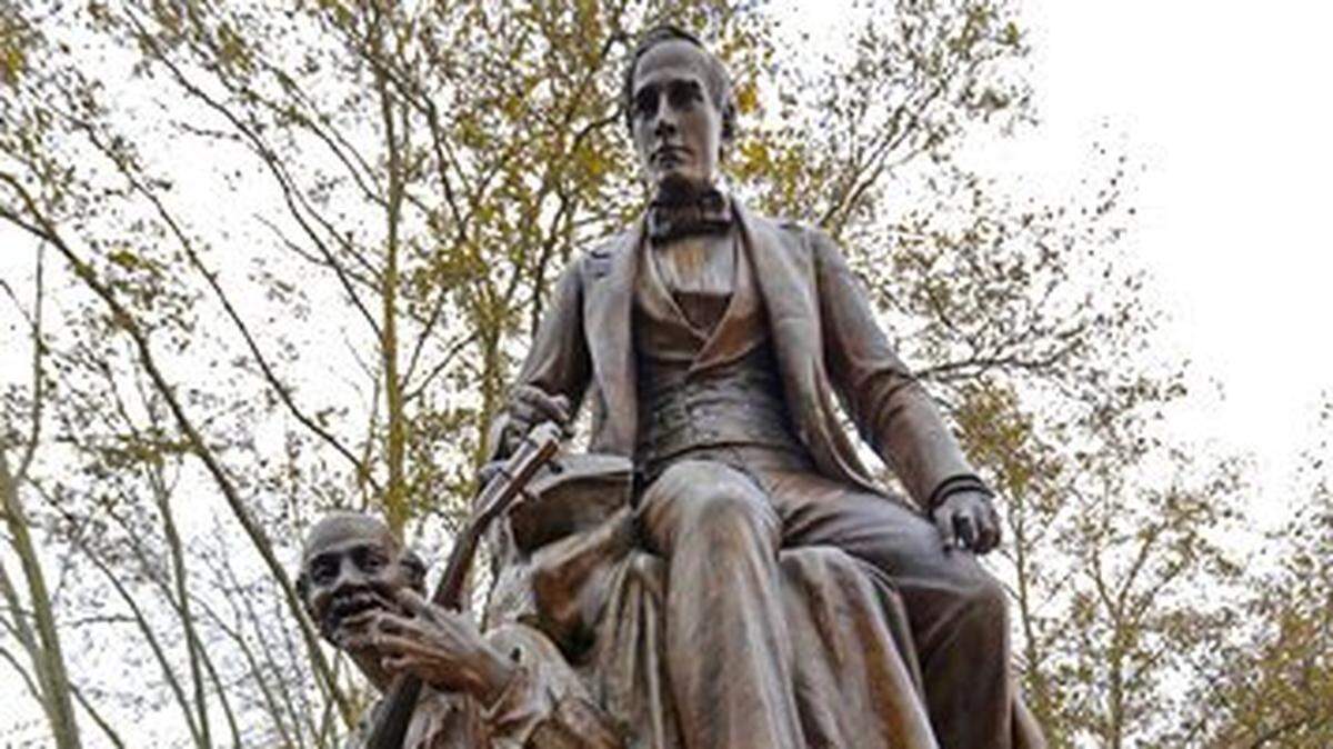 This Oct. 26, 2017, file photo, shows a bronze sculpture of 19th-century songwriter Stephen Foster, top, by Giuseppe Moretti, near the entrance to Carnegie Music Hall in Schenley Plaza in the Oakland neighborhood of Pittsburgh. Workers removed the 118-year-old statue of the “Oh! Susanna” songwriter from the Pittsburgh park Thursday, April 26, 2018, in response to criticism the work is demeaning because it includes a slave sitting at the composer’s feet, plucking a banjo. The Pittsburgh Art Commission voted unanimously Oct. 25, 2017, to relocate the statue.