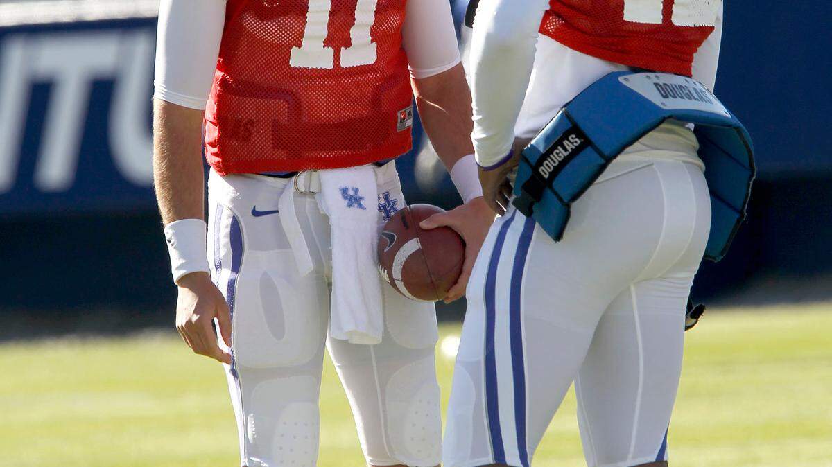 Quarterbacks 11-Maxwell Smith and 12-Morgan Newton talked before a morning UK football scrimmage at Commonwealth Stadium in Lexington, Ky., Saturday, April 07, 2012. Charles Bertram | Staff
