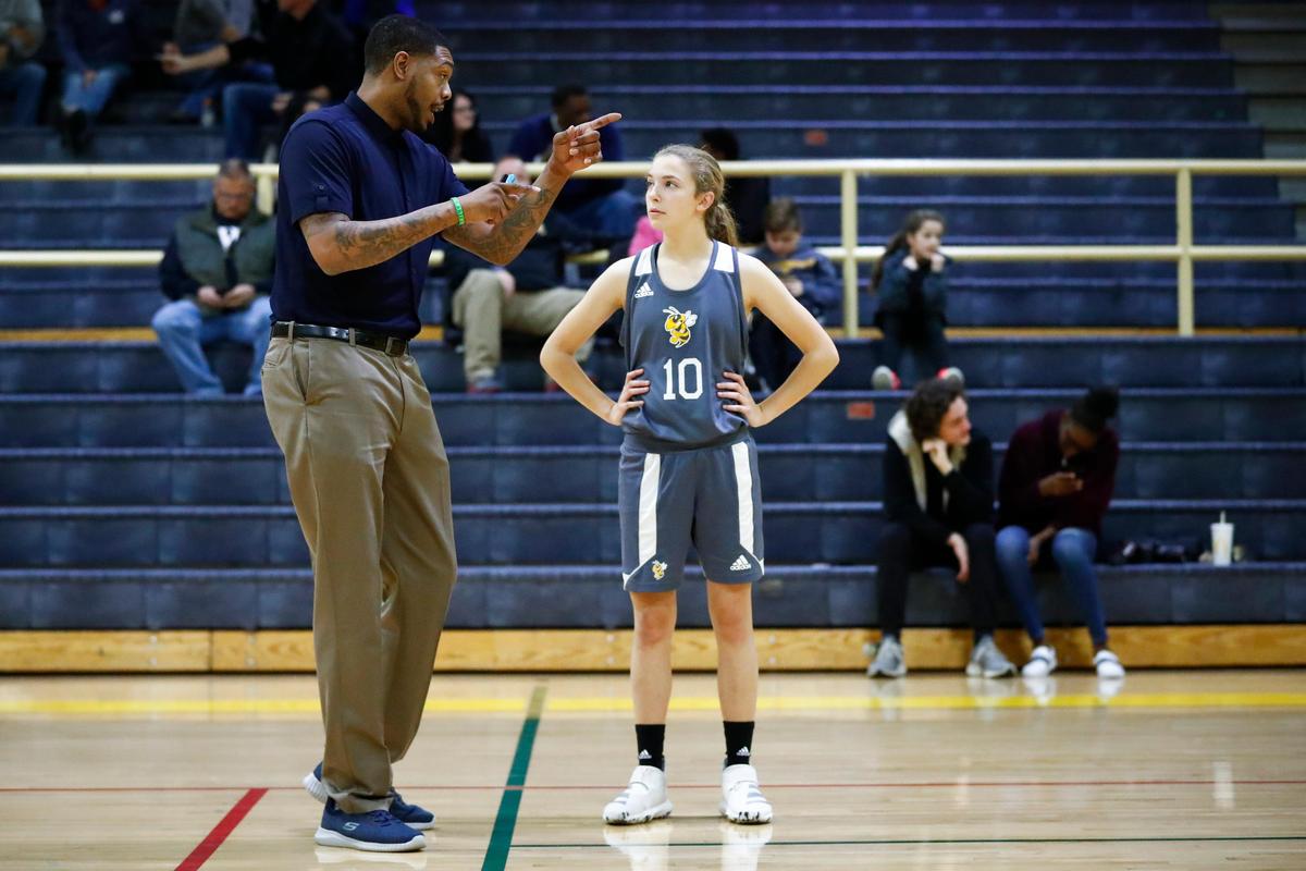 Woodford County head coach Erik Daniels spoke with Mackenzie Karo (10) before a recent game. Daniels played for the University of Kentucky from 2000 through 2004.