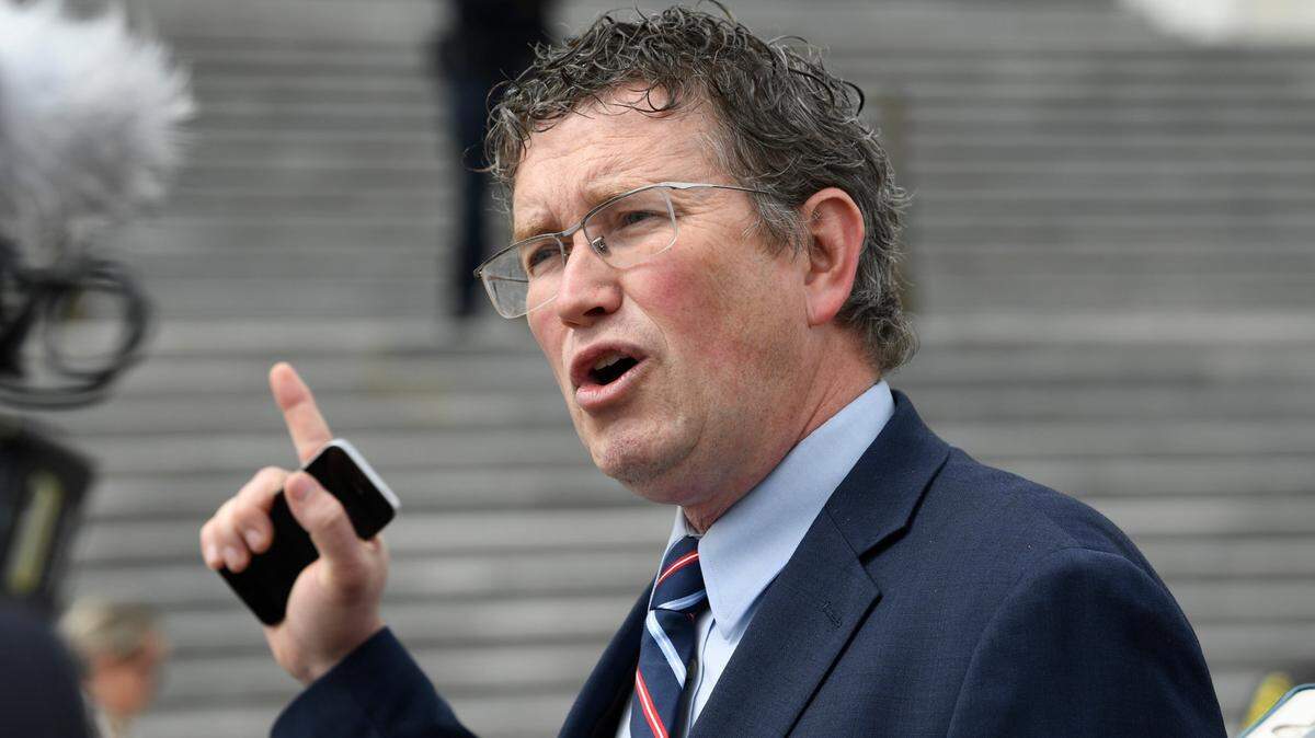 FILE - Rep. Thomas Massie, R-Ky., talks to reporters before leaving Capitol Hill in Washington, Friday, March 27, 2020, after attempting to slow action on a rescue package. Massie who has been critical of pandemic mask and vaccine mandates said he has tested positive for COVID-19, Thursday, Jan. 20, 2022. (AP Photo/Susan Walsh, File)