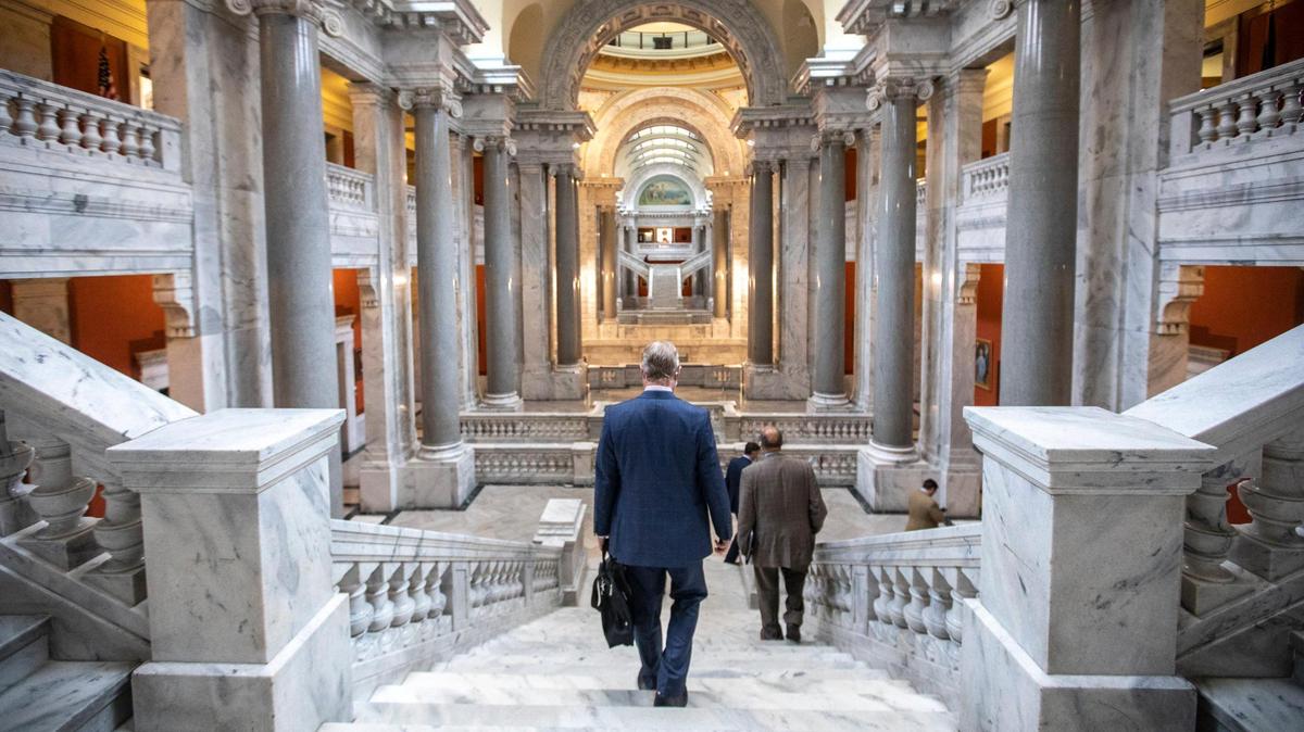 Kentucky state Sen. Damon Thayer, left, R-Georgetown, walks down stairs at the Kentucky state Capitol in Frankfort, Ky., on Friday, March 12, 2021.