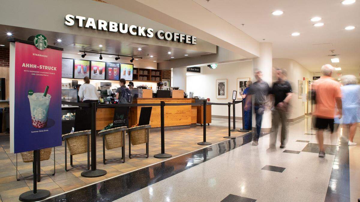 People walk past the Kentucky Clinic Starbucks in Lexington, Ky on Tuesday, July 16, 2024.