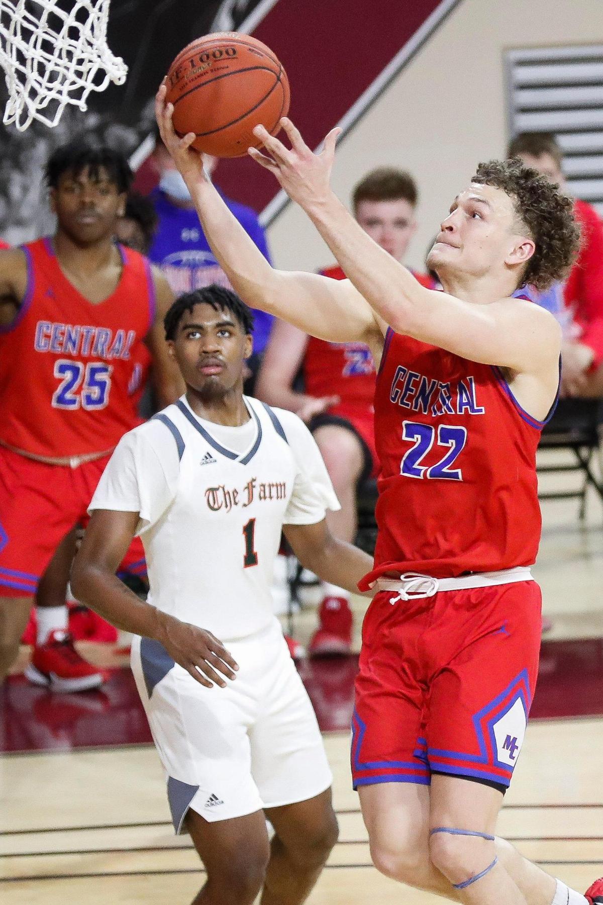 Madison Central’s Kole Browne (22) shoots over Frederick Douglass’s Dashawn Jackson (1) during the 11th Region Tournament.