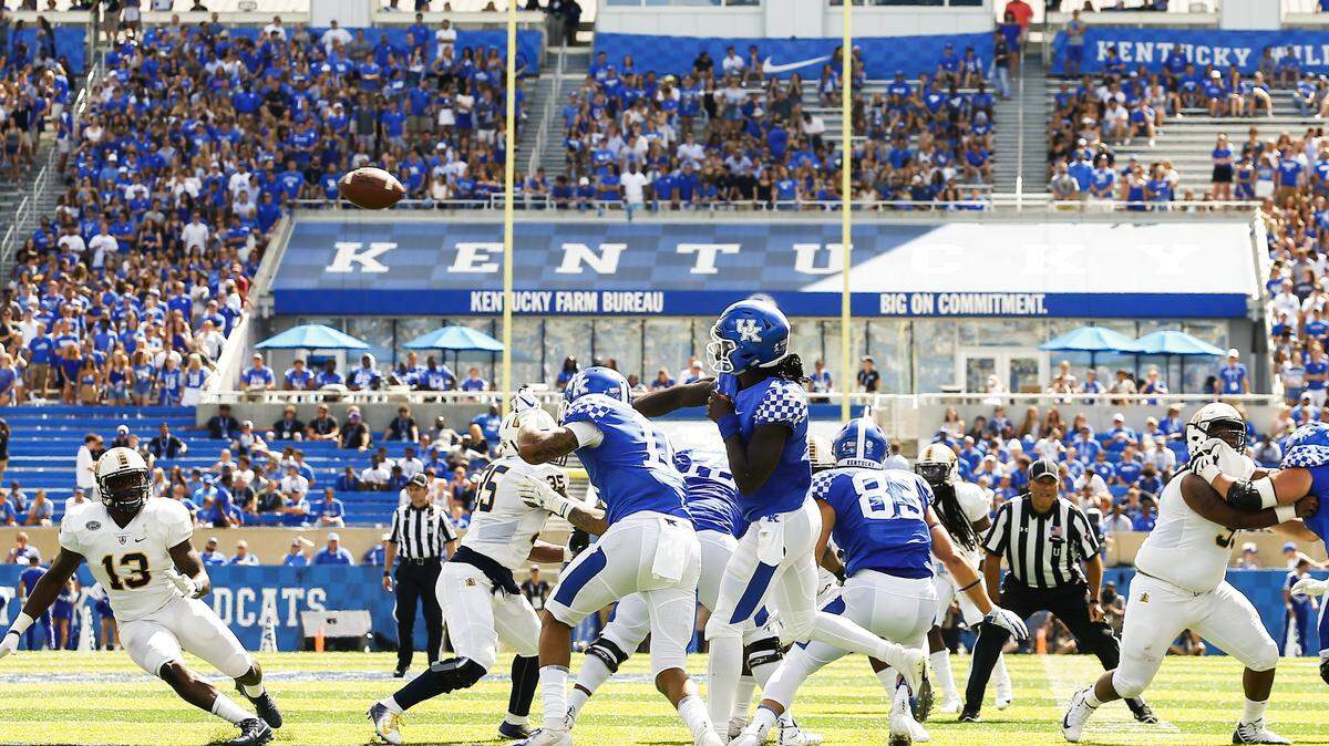 Kentucky Wildcats quarterback Terry Wilson (3) passed the ball over Murray State Racers defenders during their game Saturday at Kroger Field in Lexington. UK’s first two home games have drawn less than 50,000 each. The Wildcats play host to No. 14-ranked Mississippi State on Saturday, Sept. 22, 2018.