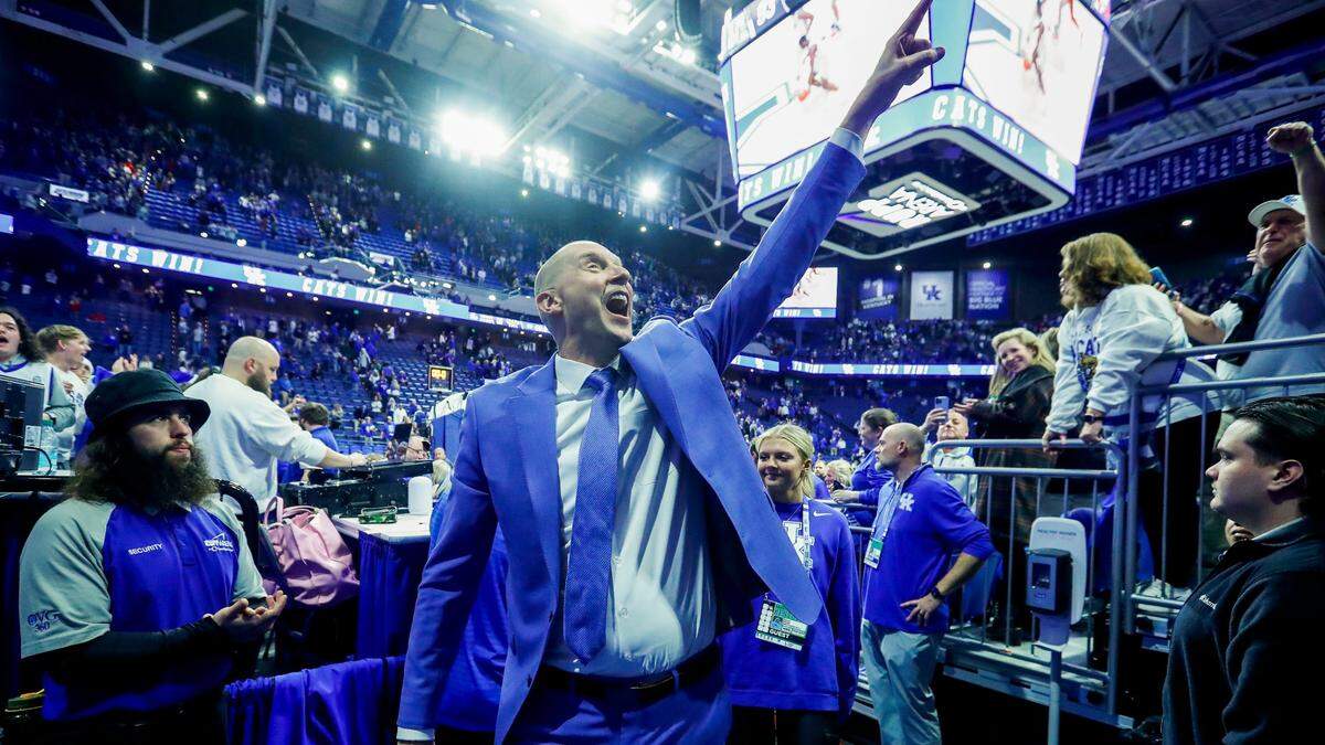 Kentucky men’s basketball coach Mark Pope celebrated with UK fans after his team beat rival Louisville 93-85 on Dec. 14 in Rupp Arena.