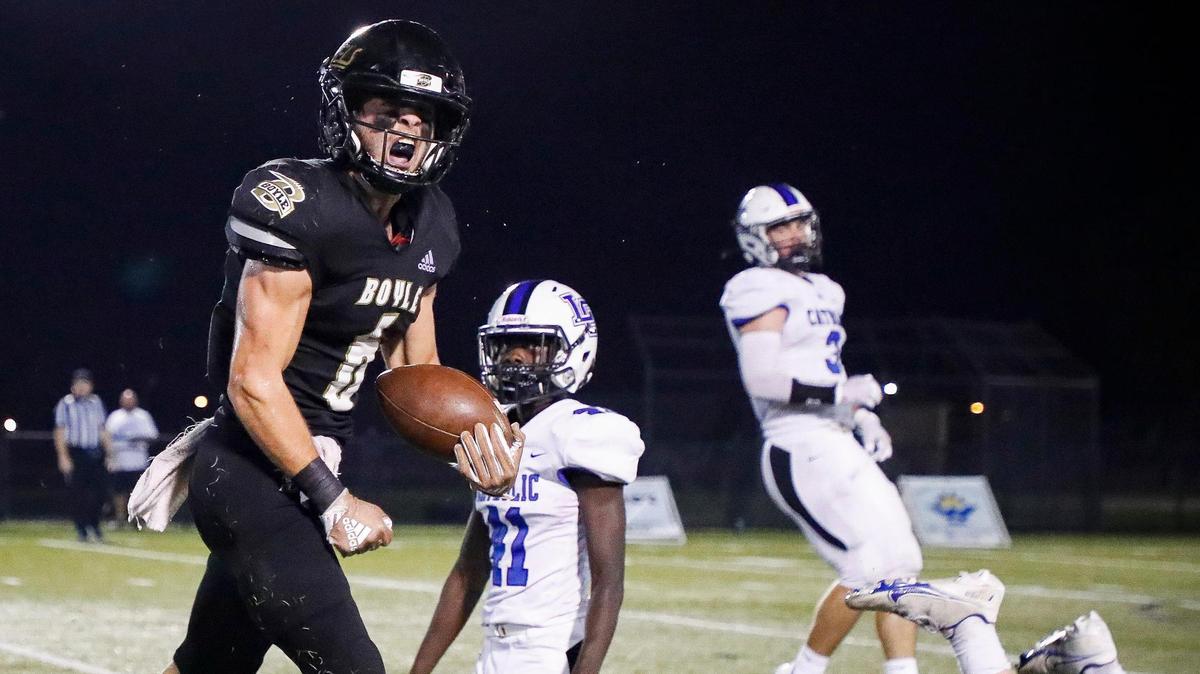 Boyle County’s Cole Lanter (6) celebrates after a run past Lexington Catholic’s Erickson Pierre-Louis (41) during a game on Oct. 8. The Rebels won 16-10.