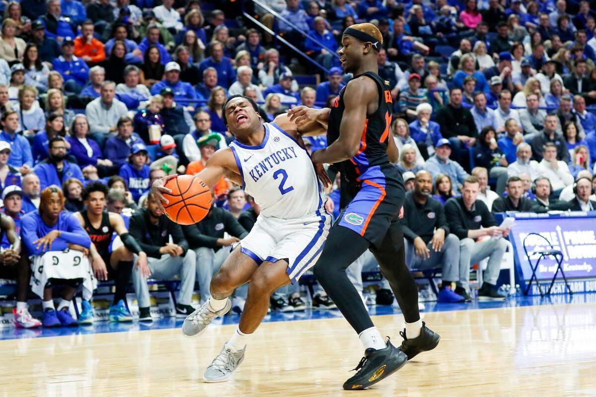 Kentucky’s Sahvir Wheeler (2) drives to the basket against Florida’s Kowacie Reeves (14) during Saturday’s game at Rupp Arena.