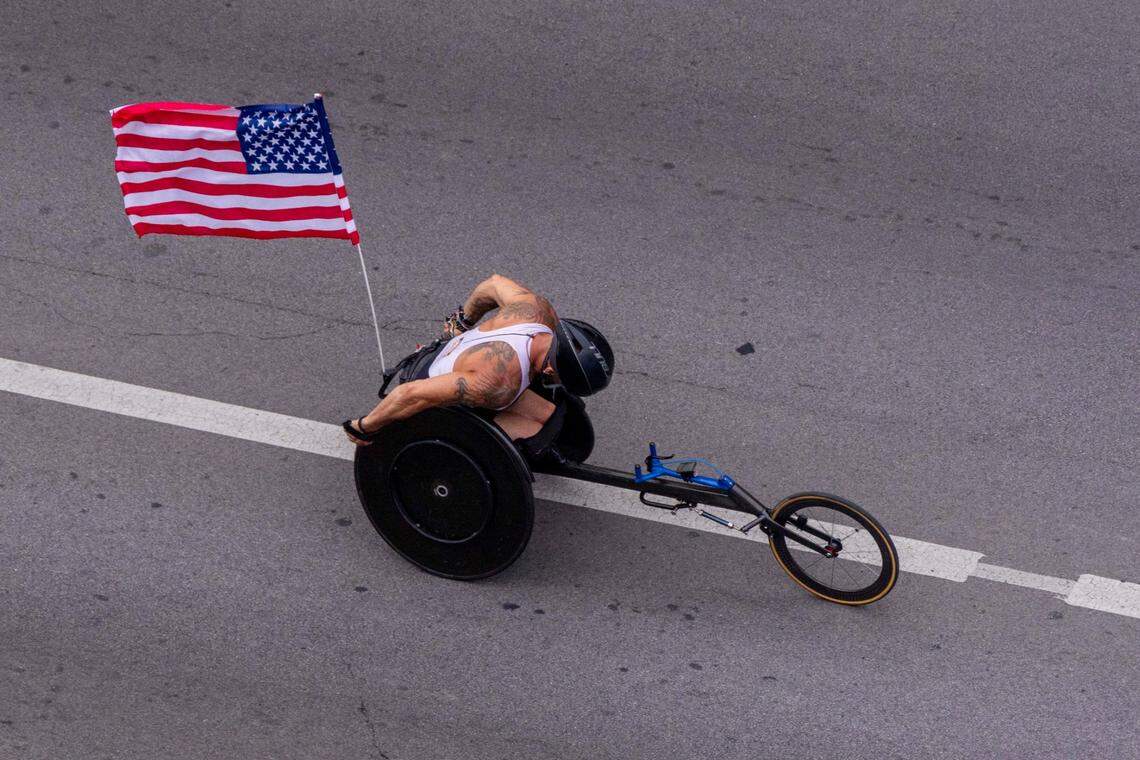 Wheelchair race participant crossing the finishline during the Bluegrass 10k race on July 4, 2024, downtown Lexington, Ky.