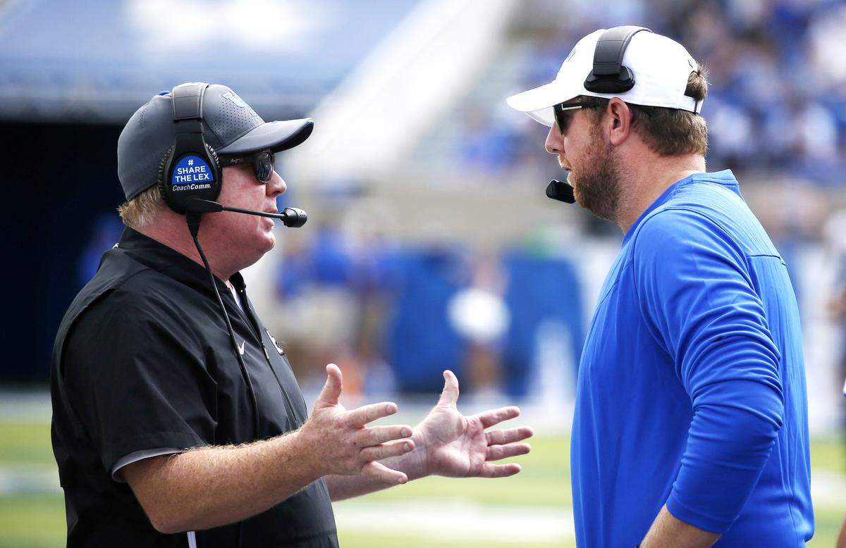Kentucky head coach Mark Stoops, left, brought Liam Coen, right, to Lexington in January of last year to change the direction of the Wildcats’ offense. After one season together, Stoops will again be looking for a new offensive coordinator.