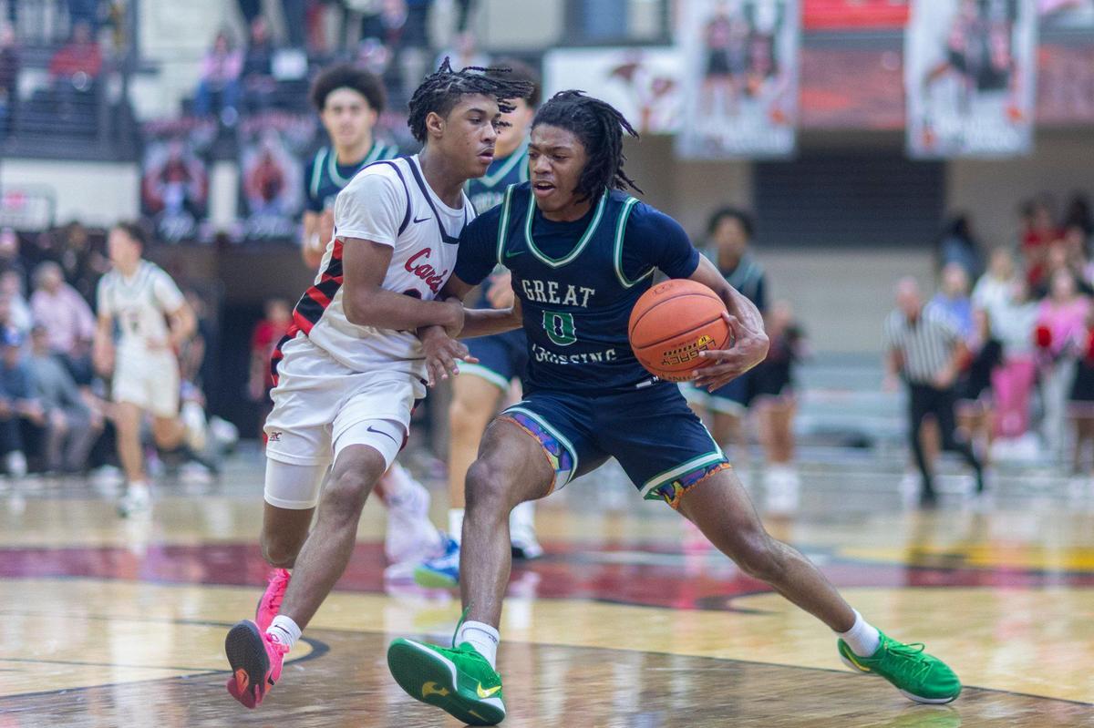 Great Crossing’s LJ Holman (0) drives against George Rogers Clark’s Malachi Ashford (3) during their game in Winchester on Wednesday.