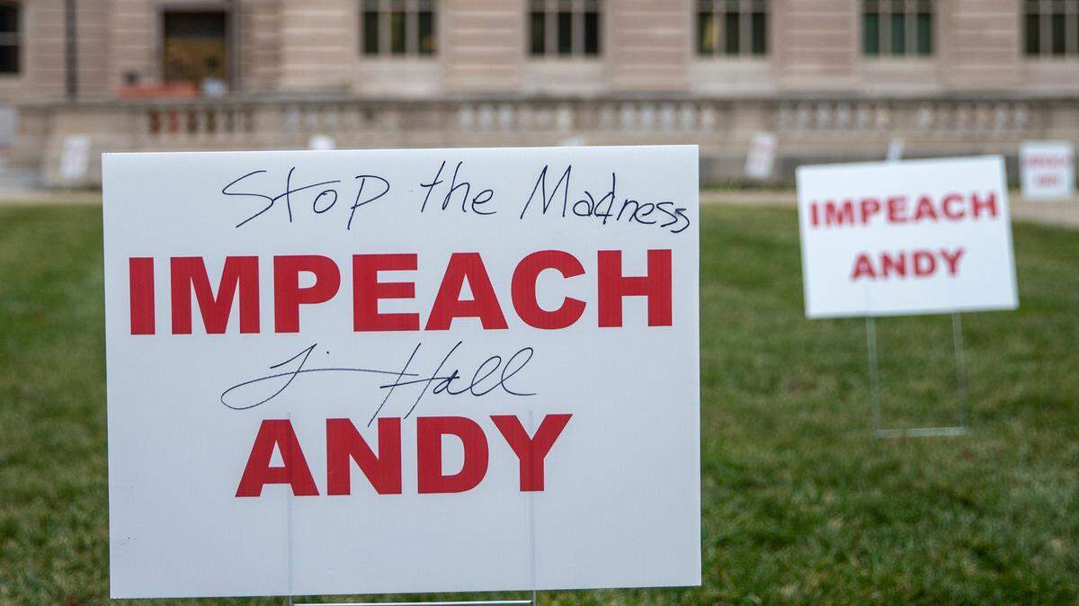 Signs calling for the impeachment of Kentucky Gov. Andy Beshear were placed on the lawn of the state Capitol in Frankfort, Ky., on Tuesday, Jan. 5, 2021.
