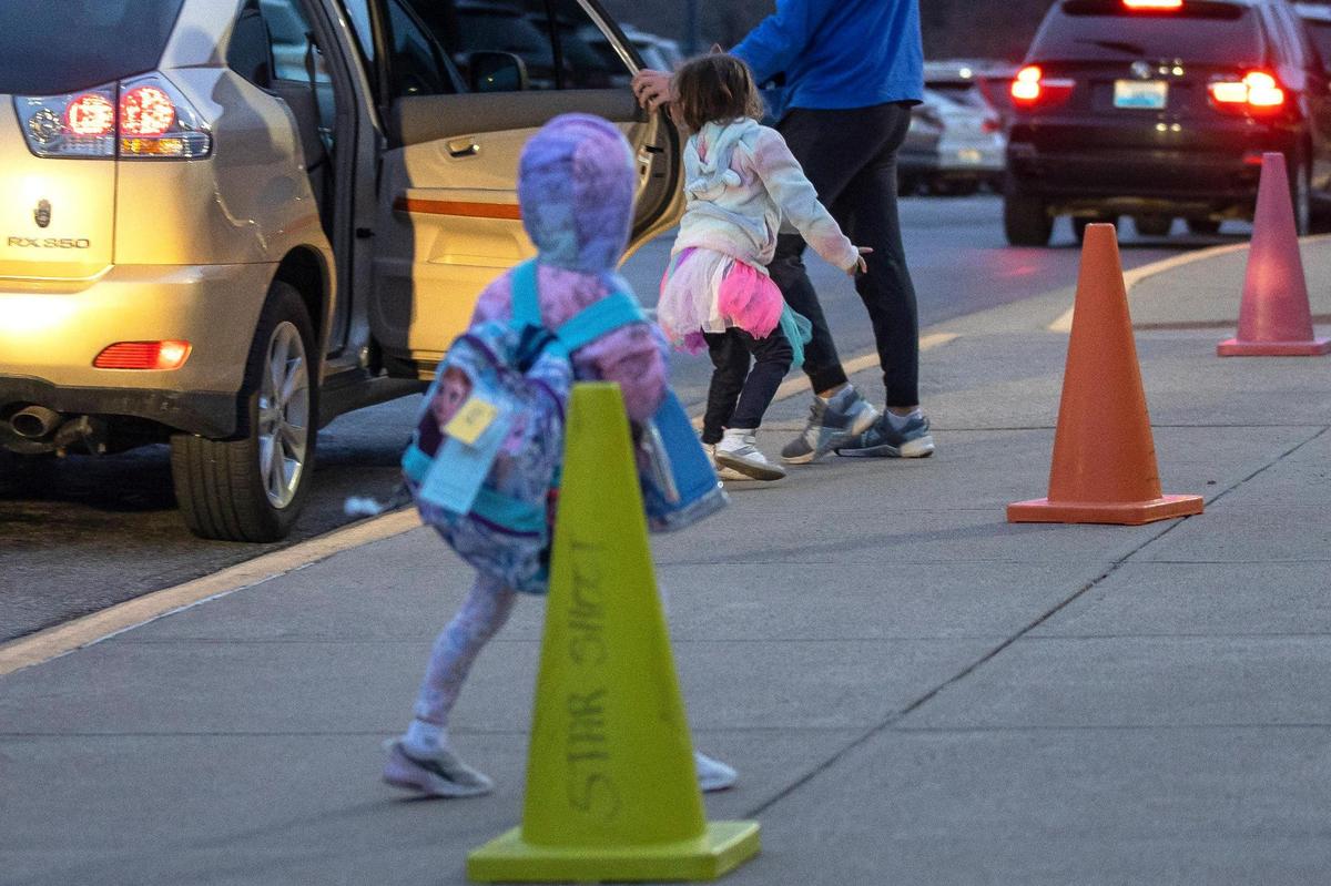 Students arrive in the drop-off line at Liberty Elementary School in Lexington, Ky., on Tuesday, March 15, 2022, the first day masks were optional in Fayette County Public Schools.