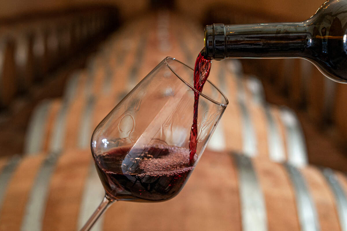 The stock image shows a red wine being poured.