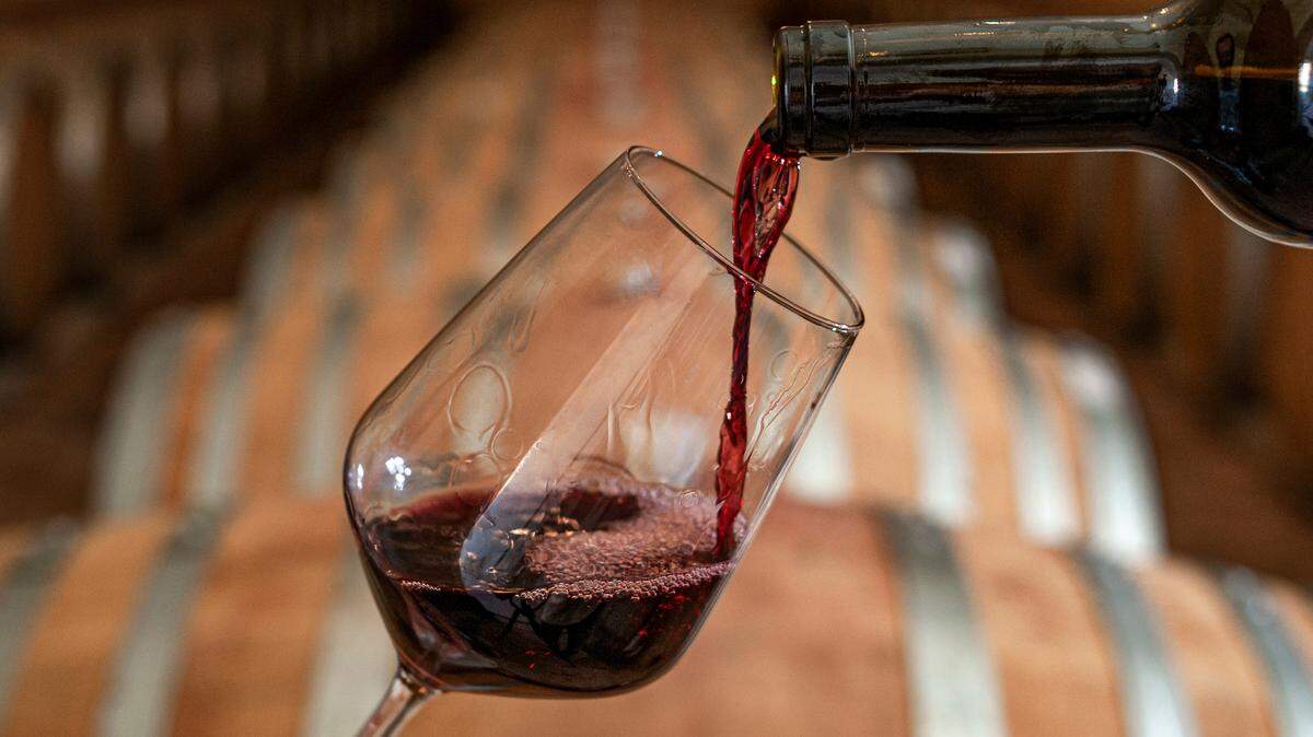 The stock image shows a red wine being poured.