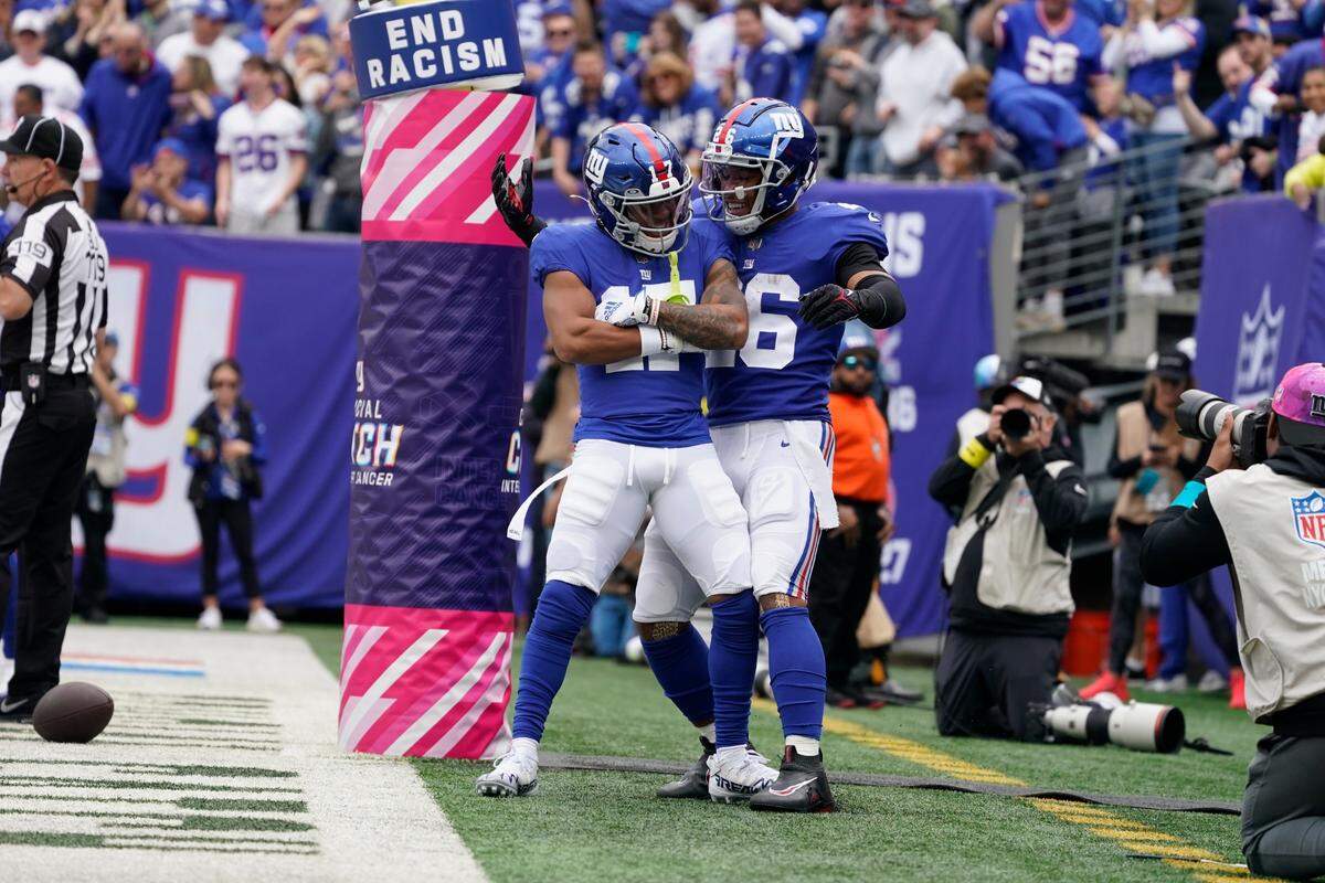New York Giants’ Wan’Dale Robinson (17) celebrates with teammate Saquon Barkley (26) after scoring a touchdown during the first half of an NFL football game against the Baltimore Ravens Sunday, Oct. 16, 2022, in East Rutherford, N.J.