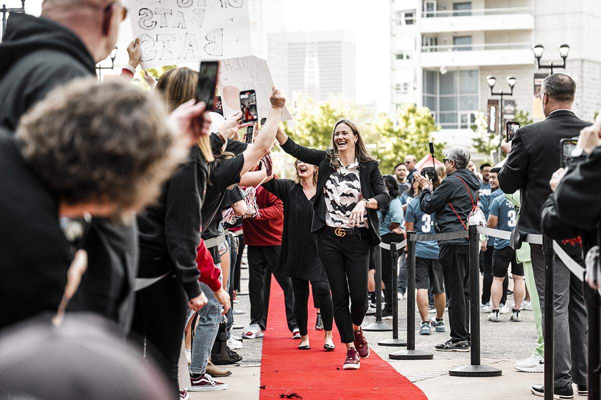 Transylvania women’s basketball head coach Juli Fulks walks on the red carpet from the team bus to inside the American Airlines Center prior to the NCAA Division III Tournament championship game on Saturday in Dallas.