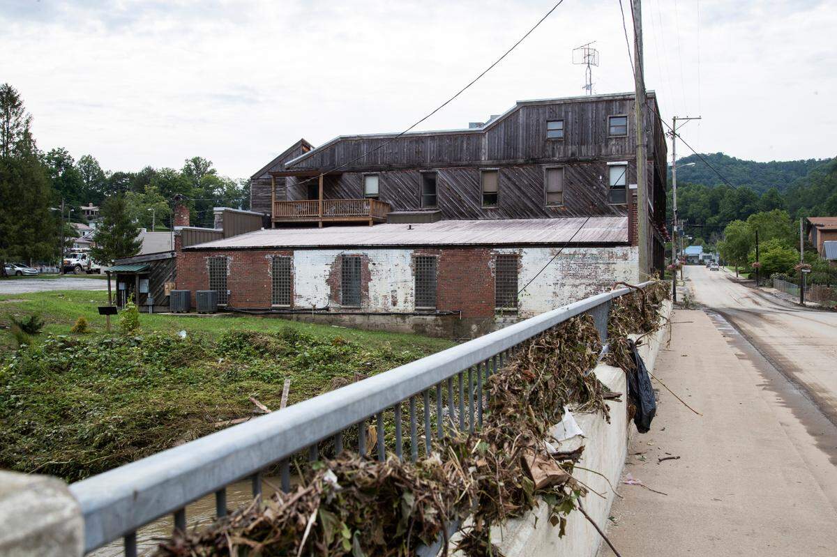 Debris sit piled up on and around a bridge over the North Fork of the Kentucky River where Appalshop sits on the bank in Whitesburg, Ky., Saturday, July 30, 2022.