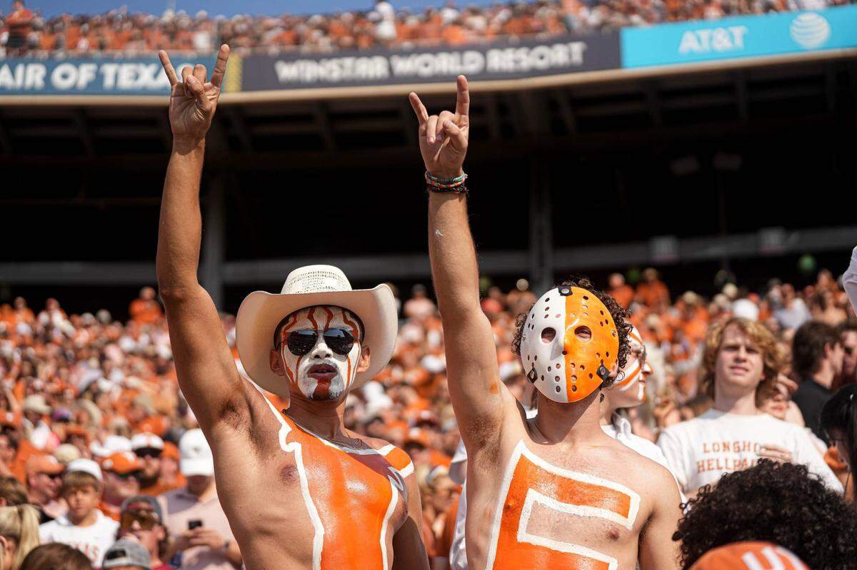 Oct 8, 2022; Dallas, Texas, USA: Texas Longhorns fans hold up the sign of the horns during the annual Red River Showdown against the Oklahoma Sooners at the Cotton Bowl. Mandatory Credit: Aaron E. Martinez/Austin American-Statesman- USA TODAY NETWORK