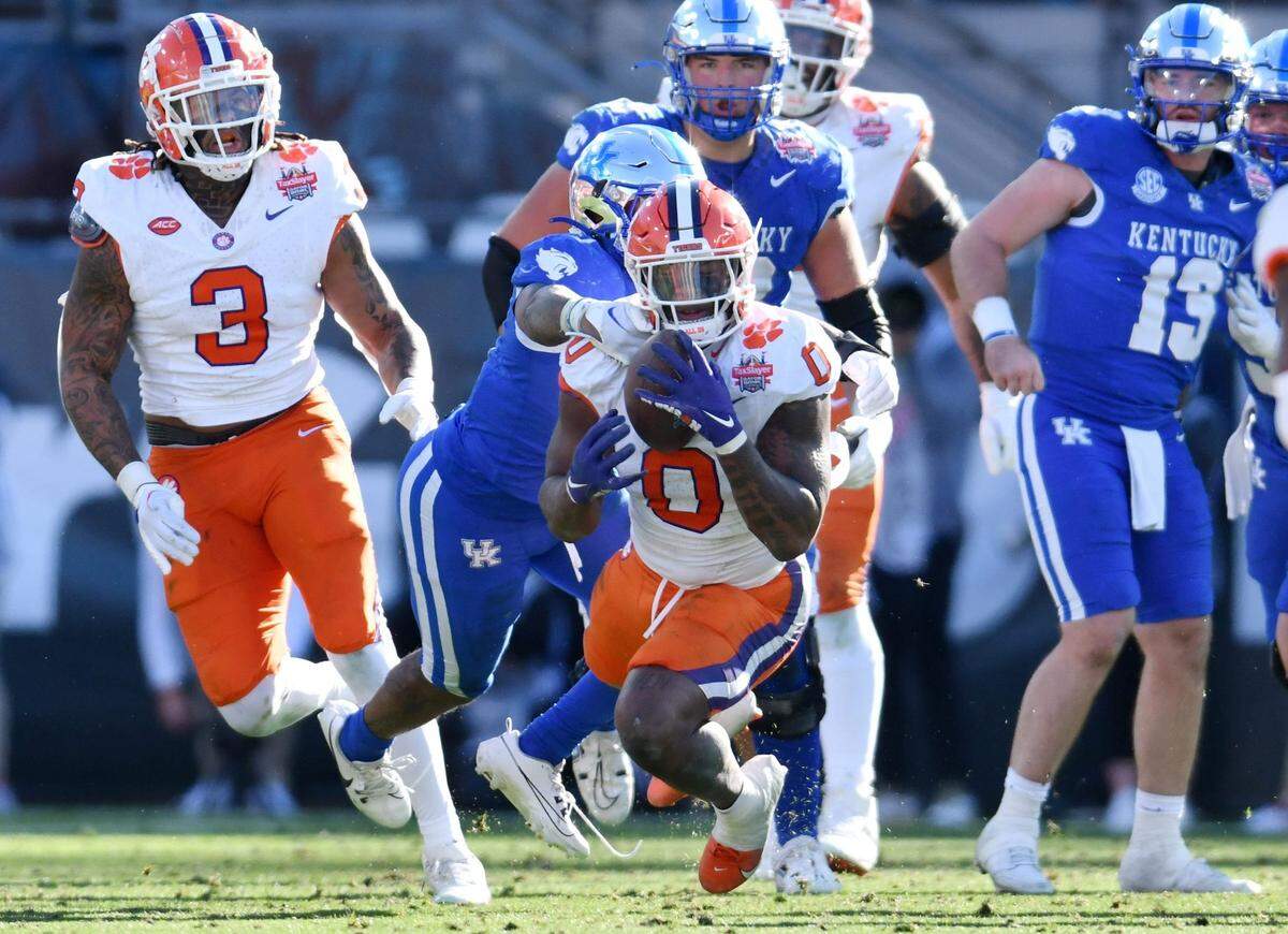 Clemson linebacker Barrett Carter (0) pulls in a deflected Kentucky pass for an interception during the fourth quarter of the Gator Bowl. The Wildcats led 14-10 at the half, but the Tigers fought back for a 38-35 victory.