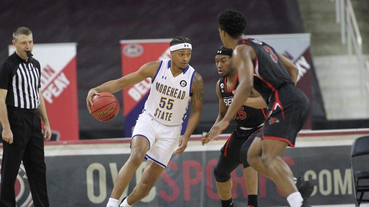 Ta’lon Cooper (55) looked to split a pair of Southeast Missouri State defenders during the Eagles’ 61-54 OVC Tournament quarterfinal win. Cooper led Morehead State with 17 points.