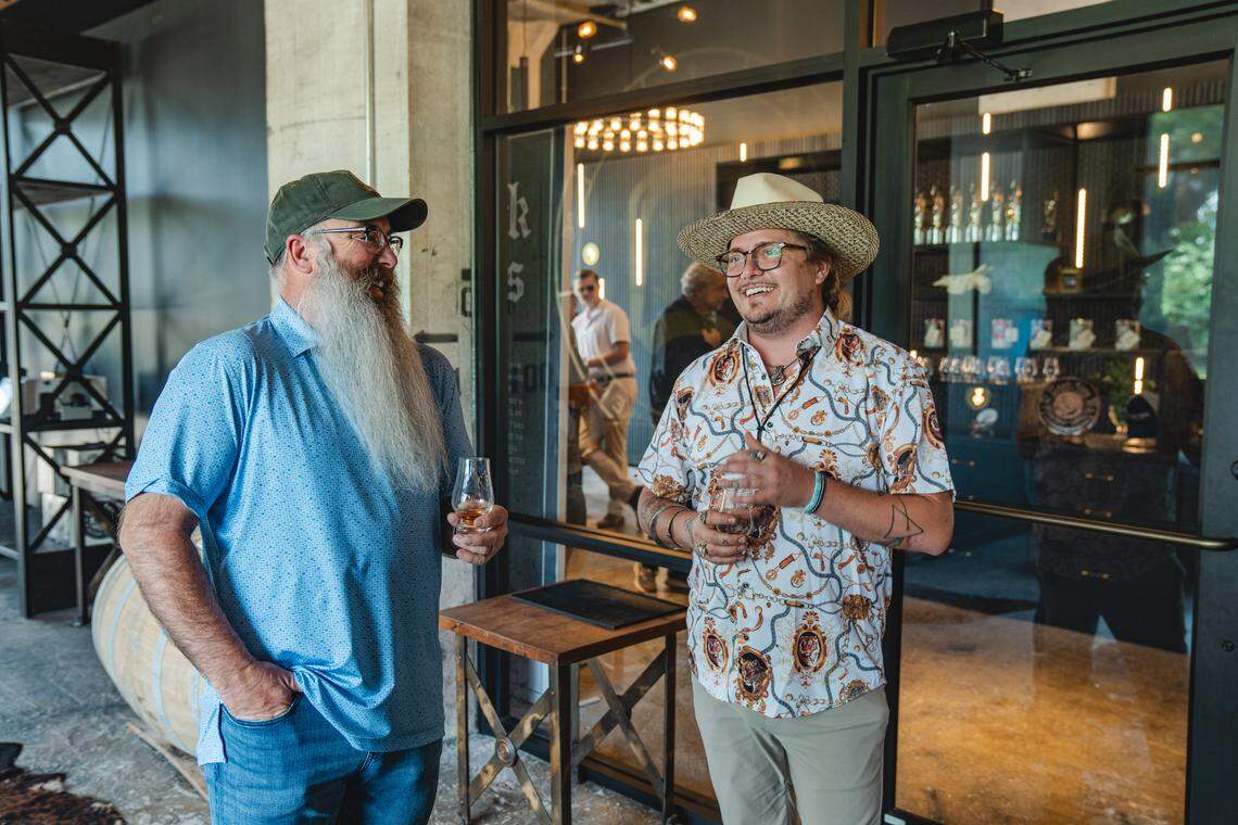 Dark Arks Whiskey’s chief alchemist Macaulay Minton, right, with RD1 Spirits’ co-founder Barry Brinegar at the Dark Arts tasting room in Lexington.