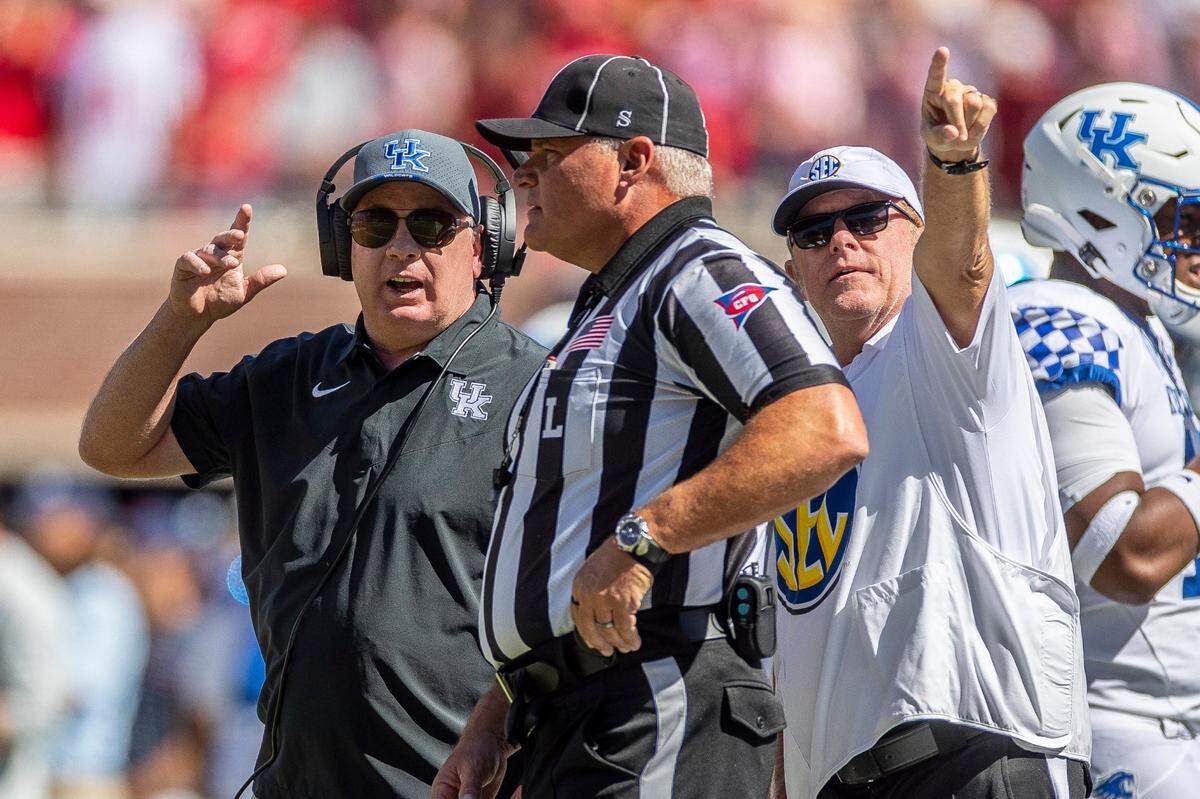 Kentucky head coach Mark Stoops talks to the officials during Saturday’s game. The Wildcats saw their eight-game winning streak snapped with the loss at Ole Miss.