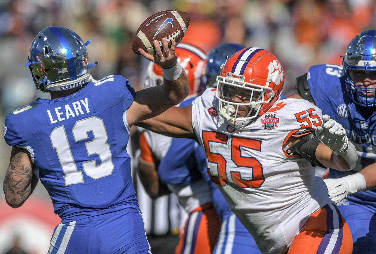 Clemson defensive tackle Payton Page (55) pressures Kentucky quarterback Devin Leary (13) during the second quarter of the TaxSlayer Gator Bowl.