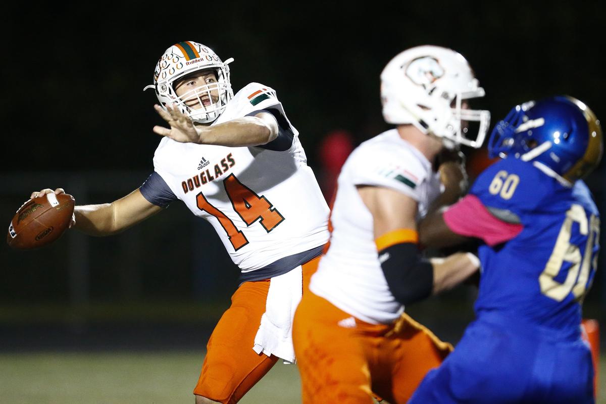Frederick Douglass’ Cameron Jones (14) passed the ball over Henry Clay defenders during their game Friday at Henry Clay High School.