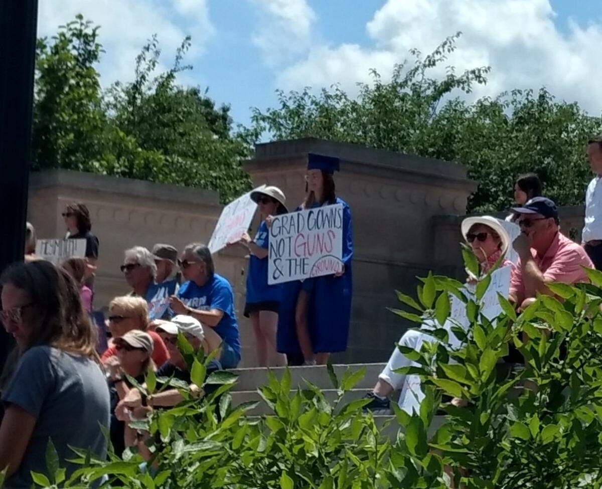 A demonstrator at the March for Our Lives rally in Frankfort, Ky., Saturday carried a sign that said, “Grad gowns not guns & the ground.”