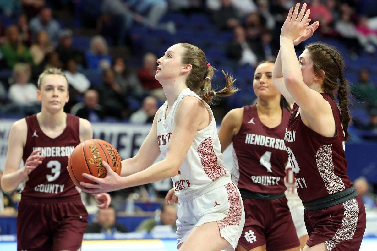 McCracken County’s Claire Johnson, middle, shoots the ball while surrounded by the Henderson County defense during their semifinal game in the Mingua Beef Jerky Girls’ Sweet 16 on Saturday.