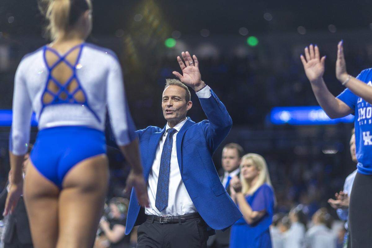 Kentucky coach Tim Garrison congratulates Delaynee Rodriguez after her performance on the balance beam on Friday night. UK improved to 4-2 overall and 2-1 in the SEC this season facing a visit next to No. 1 Oklahoma.