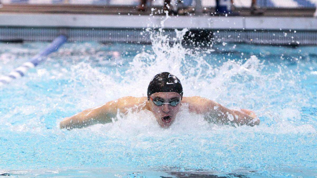 Lexington Catholic’s Zach Hils swam the boys’ 100-yard butterfly Saturday at the 8th Region swimming and diving championships.