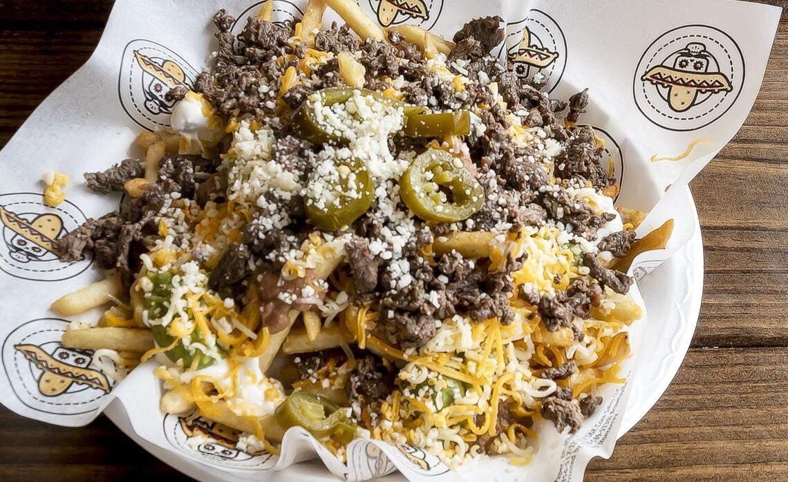 The Bandido Super Fries are french fries loaded with either grilled steak or chicken, refried beans, sour cream, guacamole, jalapenos, cotija cheese and shredded cheese or queso.