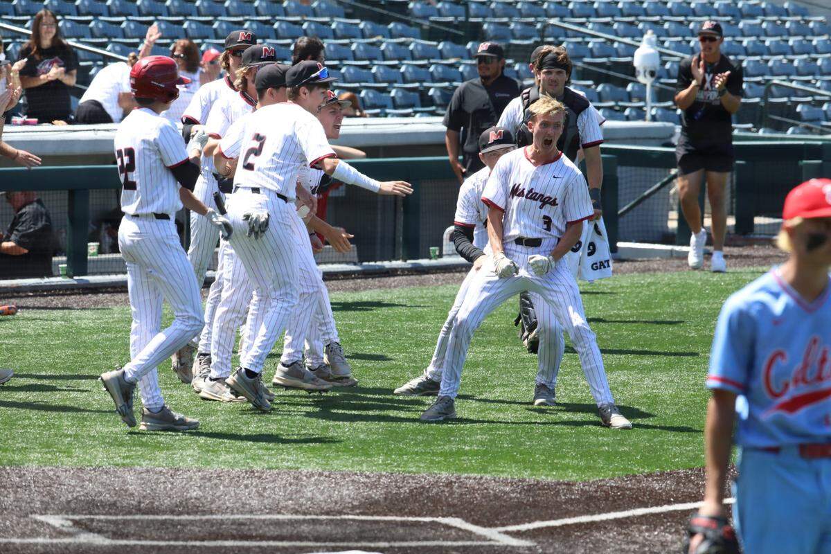 Caleb Ehling (3) and his McCracken County teammates celebrate after he scored the winning run against West Jessamine during their first-round state tournament game Friday.