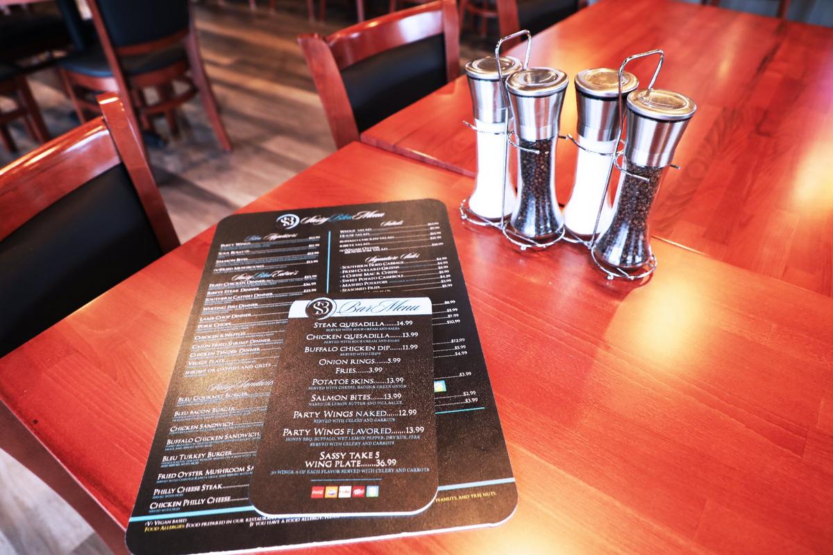 Sassy Bleu menus for the new Southern soul food restaurant, located on the corner of Woodland and High.