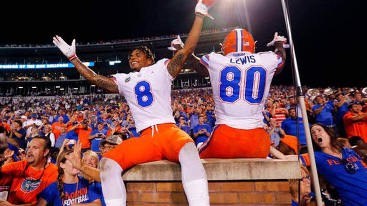 Florida wide receiver Trevon Grimes (8) and tight end C’yontai Lewis (80) lead their fans as the team celebrates a 13-6 win over Mississippi State in an NCAA college football game in Starkville, Miss., Saturday, Sept. 29, 2018.