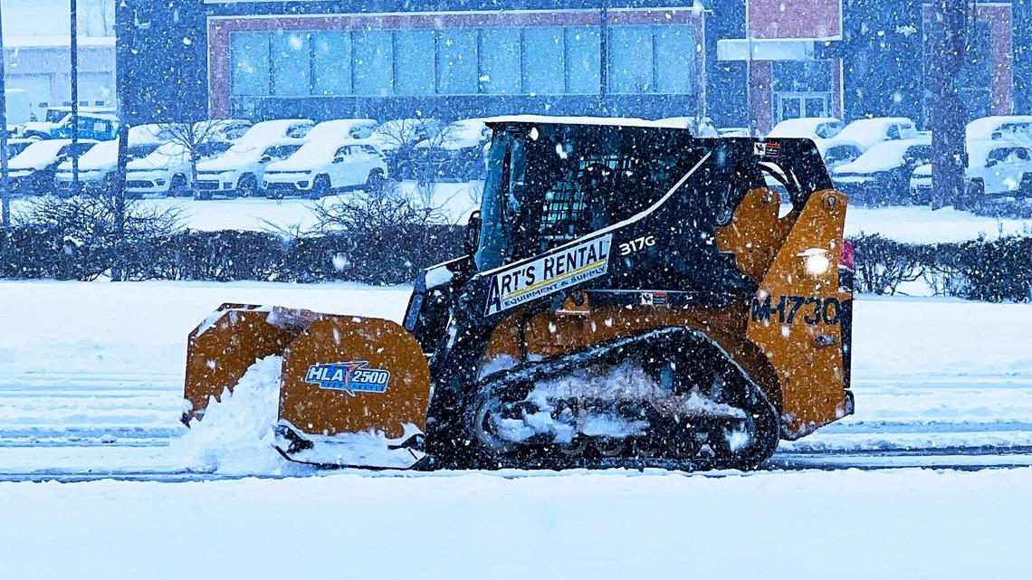 A small 317G compact track loader aids in snow removal at the Homegoods parking lot on East New Circle Road in Lexington, Ky., Jan. 5, 2025.