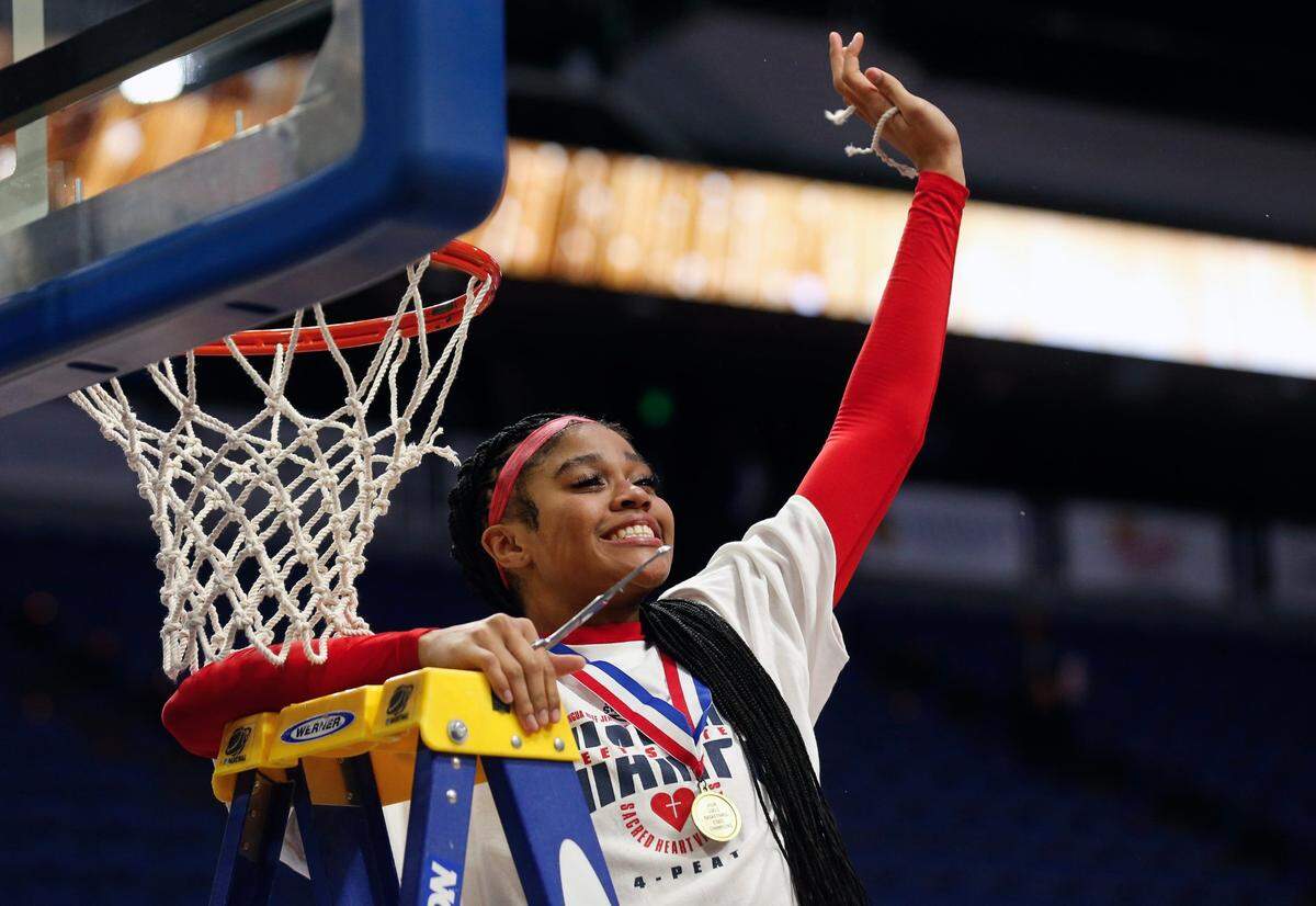 Sacred Heart's Zakiyah Johnson celebrates her piece of the net after they beat McCracken County in the Mingua Beef Jerky Sweet 16 Girl's Basketball Championship. Mar. 16, 2024