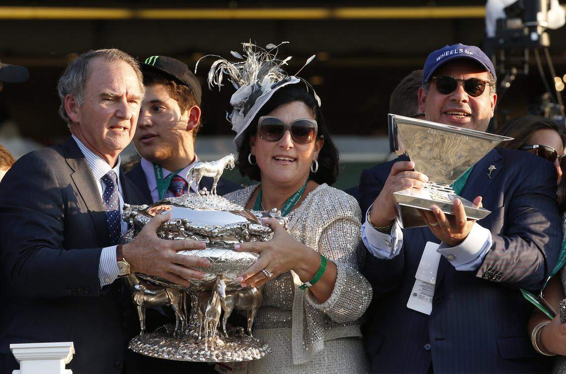 American Pharoah owner Ahmed Zayat, right, holds the Triple Crown trophy as his wife Joanne, center, and New York Racing Association CEO and President Christopher Kay hold the August Belmont trophy, after American Pharoah won the 147th running of the Belmont Stakes horse race at Belmont Park in 2015. Zayat Stables, which was sued last week in Lexington, has filed a response asking to dissolve the receivership.