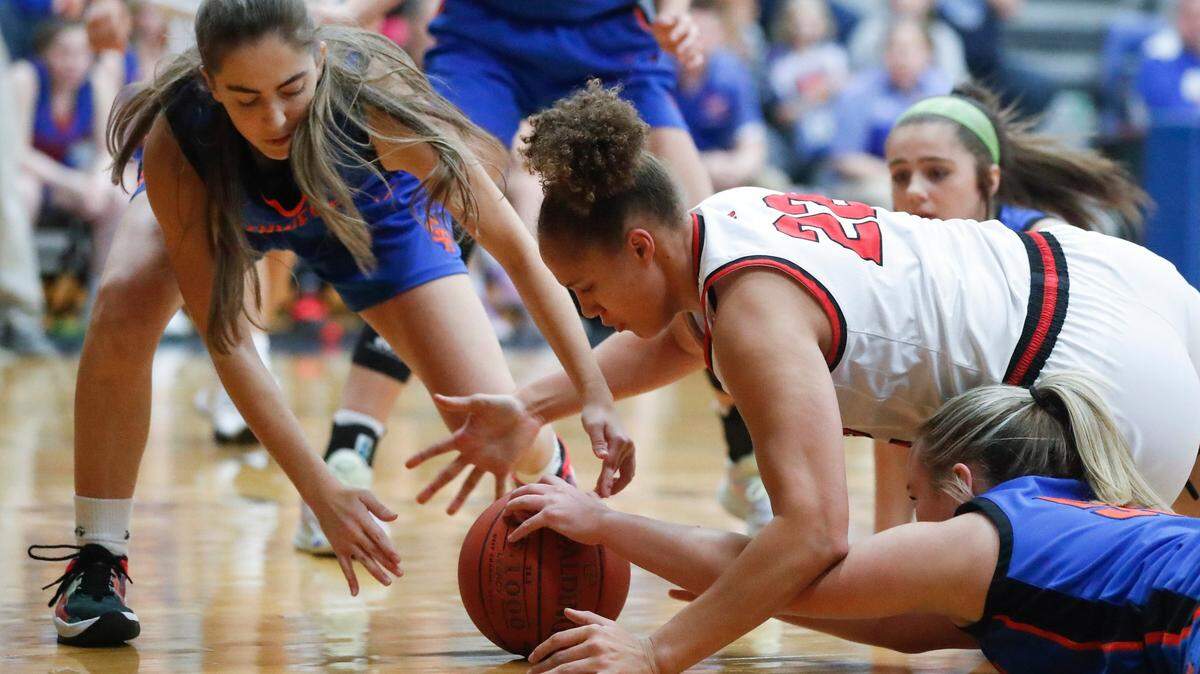 Clark County’s Tyra Flowers (22) battles for the ball with Southwestern’s Ayden Smiddy (10) and Payton Acey (55) during the White, Greer & Maggard Orthodontics Holiday Classic at Lexington Catholic High School on Dec. 21, 2021. The Cardinals won 62-61.