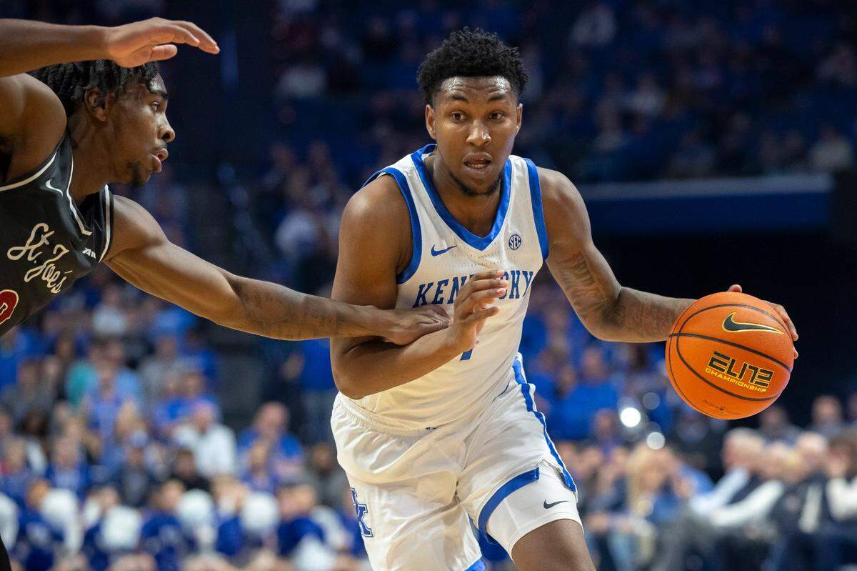Kentucky guard Justin Edwards (1) drives the ball as Saint Joseph’s guard Cameron Brown (3) defends.