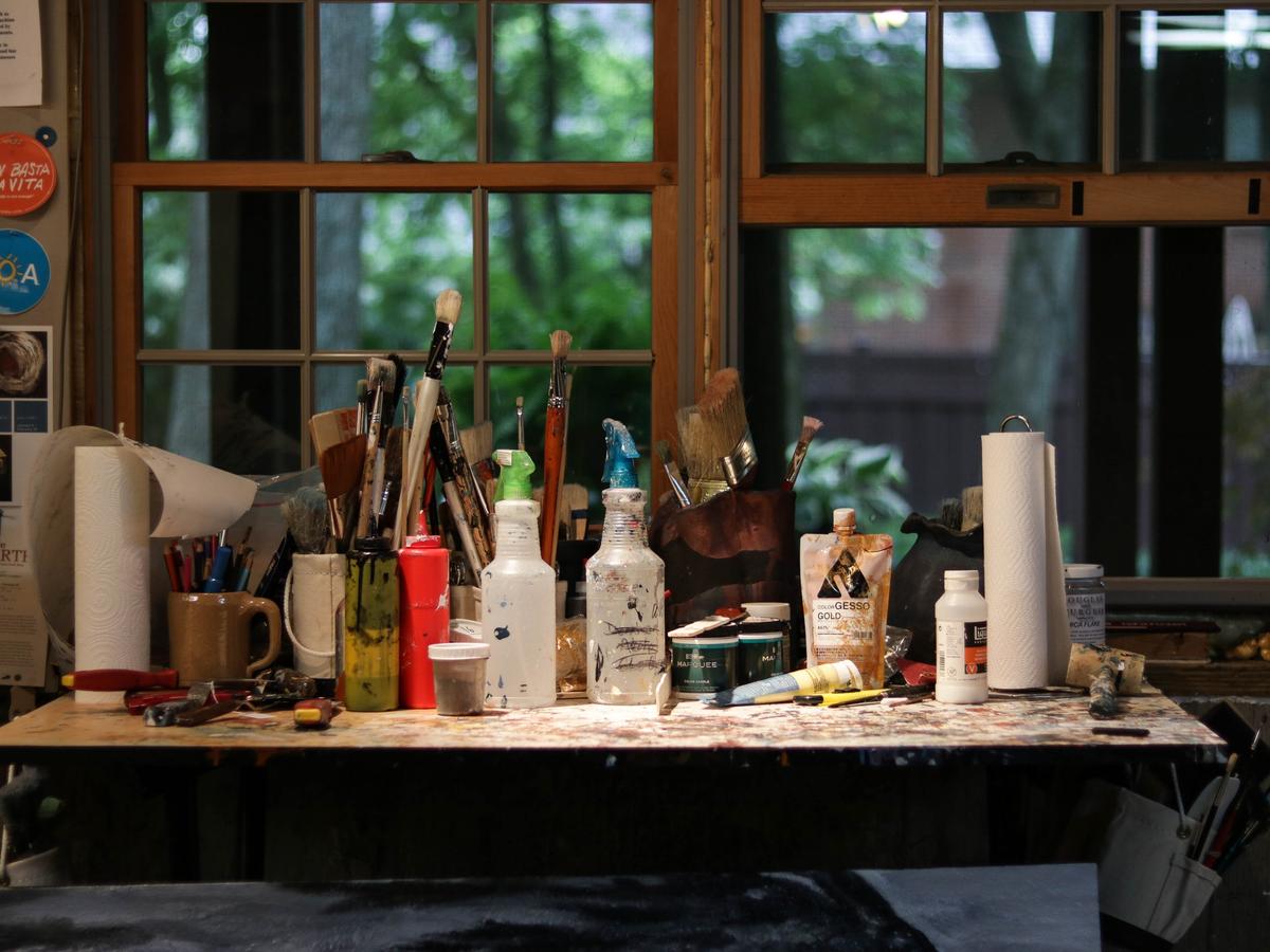 Paintbrushes, spray bottles and paper towels sit inside Ishmael's studio.