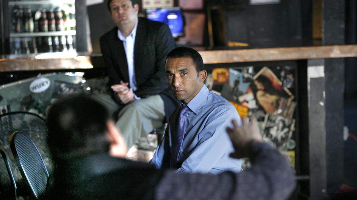 Architect and urban planner Gary Bates, center right, hired by the city's Arena, Arts & Entertainment Task Force, listened to a question from Mike Stutland, foreground, owner of Artique shop in the Lexington CenterÊon Thursday, Dec. 1, 2011 at Buster's night club in Lexington, Ky.  In background is Stan Harvey, owner of Urban Collage, Inc.    Bates presented ideas to the public regarding a revamp of the Rupp Arena/Lexington Center district.   Photo by David Perry | Staff

