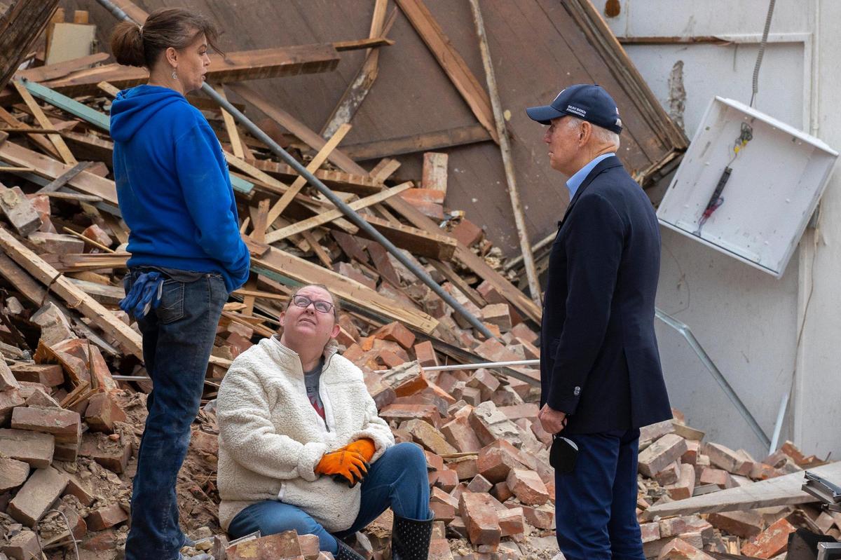 President Joe Biden talks to residents Wednesday, Dec. 15, 2021 in downtown Mayfield, Ky. as he tours damaged areas of Western Kentucky.