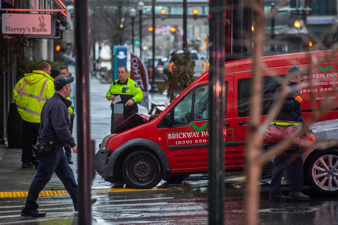 First responders from the Lexington fire and police departments respond to a crash at South Upper and West Main streets in downtown Lexington, Ky., on Thursday, Jan. 12, 2023, while a thunderstorm rolled through Fayette County.