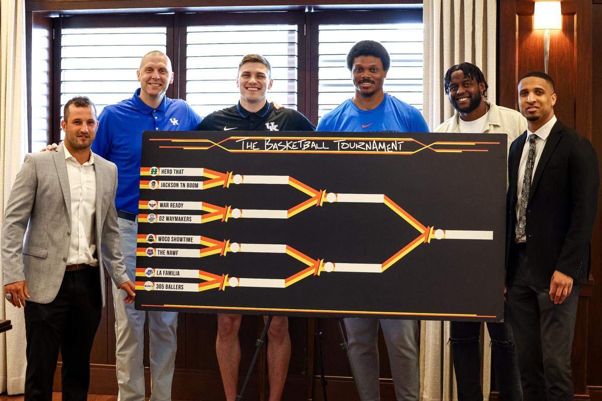 From left, Sam Malone, UK coach Mark Pope, Nate Sestina, Daniel Orton, Darius Miller and Twany Beckham pose with the Lexington TBT regional bracket.
