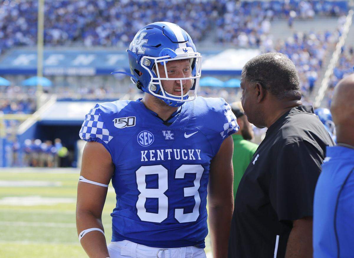 Kentucky senior Justin Rigg, left, got instruction from tight ends coach Vince Marrow on the sideline during the Wildcats’ 38-24 win over Toledo in the 2019 season opener. A 6-foot-6, 263-pound product of Springboro, Ohio, Rigg started 12 of UK’s 13 games last season.