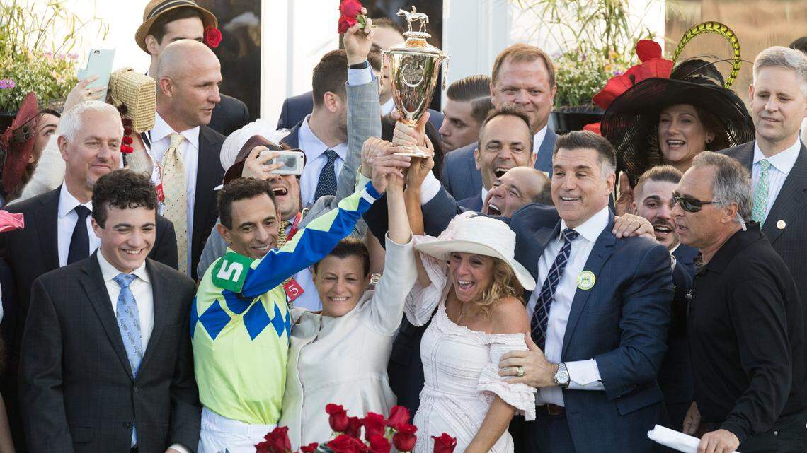 Vincent Viola, standing at right with one hand on the Kentucky Derby trophy, was a co-owner of last year's Derby champion, Always Dreaming. This year, he's back again as co-owner of Derby hopeful Vino Rosso.